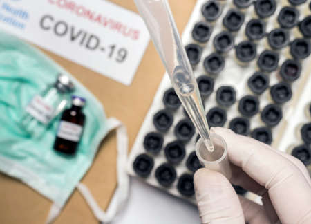 Scientist takes samples from a patient infected by Codvid-19 coronavirus in the laboratory,...