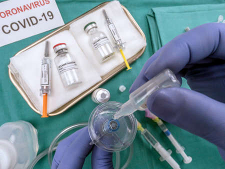 Nurse refilling medication solution nebulizer container in the hospital