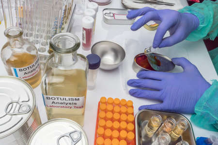 Specialist scientist opens infected canned food, botulism infection in sick people, conceptual image