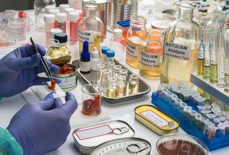 Experienced laboratory scientist analyzes red peppers from a canned food can to analyze botulism...