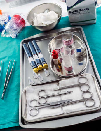 Diverse medication in glasses monodose along with insulin injectors in hospital, conceptual image