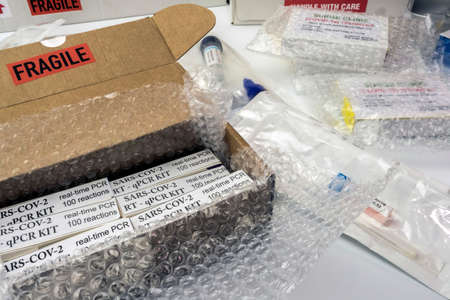 Boxes with Covid-19 PCR kit in hospital warehouse, conceptual image