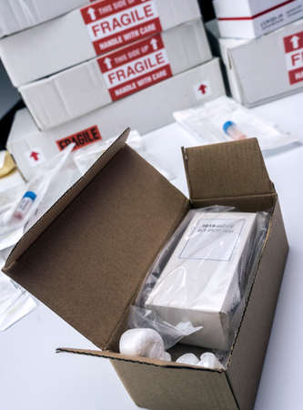 Boxes with Covid-19 PCR kit in hospital warehouse, conceptual image