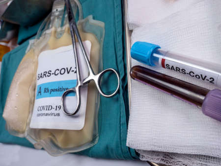 Plasma bag with antibodies from people cured of SARS-COV-2 Covid-19 prepared in a hospital, conceptual imageの写真素材