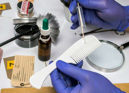 Scientist Police hold murder victim comb to find dna in crime lab, concept image