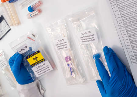 Nurse comparing positive covid-19 test results of infected persons, Conceptual image