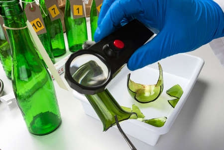 Police expert gets blood sample from glass bottle in Criminalistic Lab