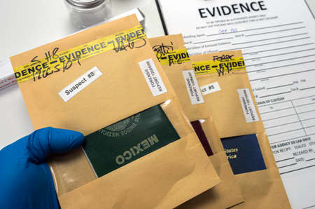 Different passports decommissioned in police investigation unit, conceptual imageの写真素材