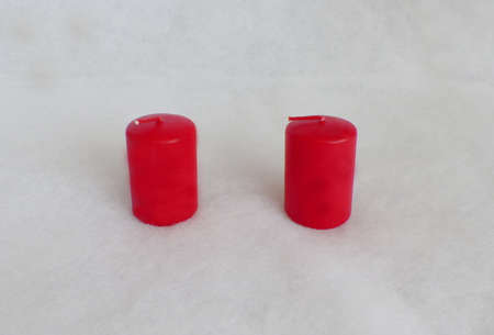 two red candles on a white backgroundの写真素材