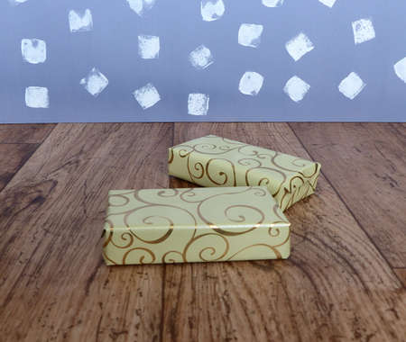 gift boxes wrapped in paper with gold decorの写真素材