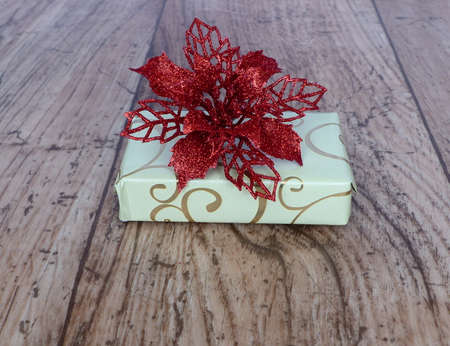 small box with a red poinsettiaの写真素材