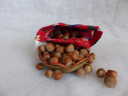 hazelnuts in a bag and basketの写真素材