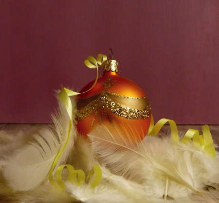 orange christmas ball with gold ornamentの写真素材