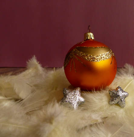 orange christmas ball with gold ornamentの写真素材