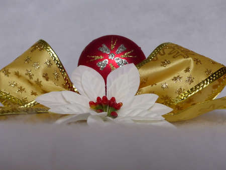 golden ribbon with poisettia and red ballの写真素材