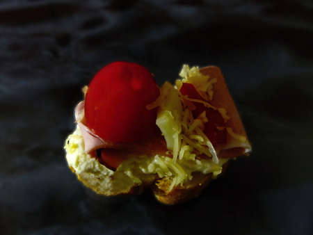 cheese ham canapes on black marbleの写真素材