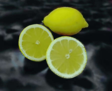 sour lemons isolated on a marble backgroundの写真素材