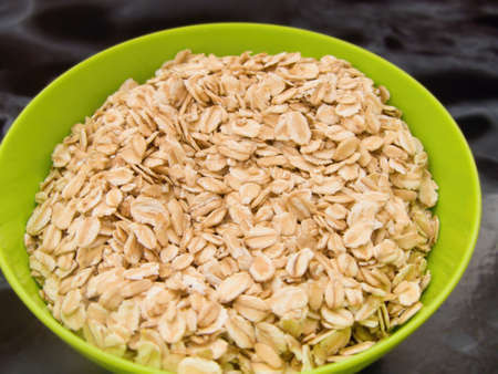oatmeal in a green bowl, for the preparation of a healthy breakfastの写真素材