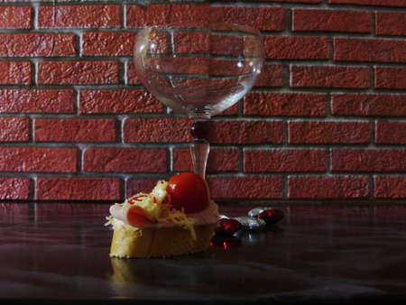wine glass with cheese canapes on black marbleの写真素材