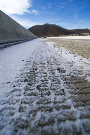 Close up of tire track with deep pattern in snowの写真素材