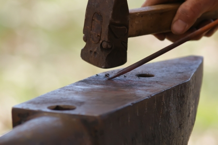 Making a decorative element in the smithy on the anvilの写真素材