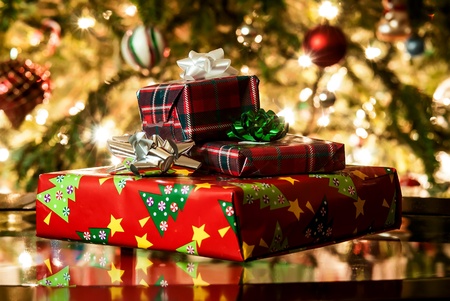 different present boxes under Christmas tree in holiday eve, Christmastime celebration, home...