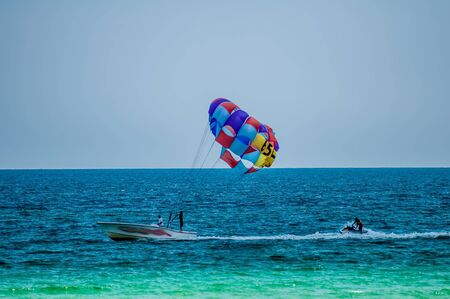 paragliding in the clear sky above the sea