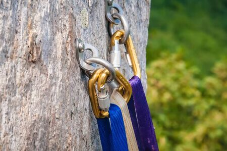 Climbing carabiner attached to the cliff rock