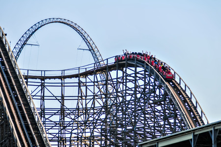 rollercoasters at an amusement park with blue skyのeditorial素材