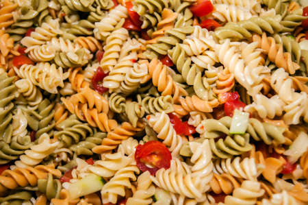 colorful cooked pasta salad for a partyの写真素材