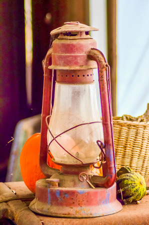rustic old oil lantern on a farmの写真素材