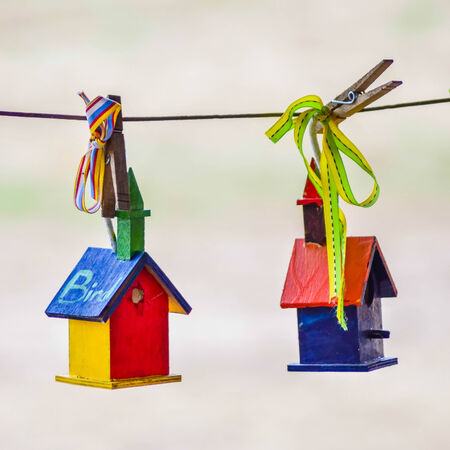little colorful bird houses on clothes lineの写真素材