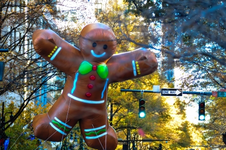 ginger bread cookie inflatable floating thru city streets at thanksgiving parade