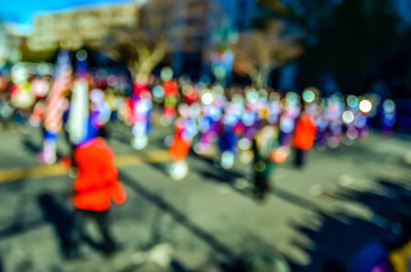 abstract and defocused image of a thanksgiving parade in a big city during holidaysの写真素材