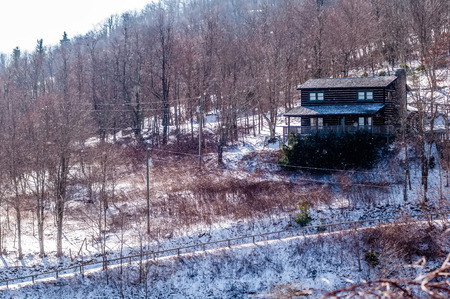 log cabin on a side of a mountain during winterのeditorial素材