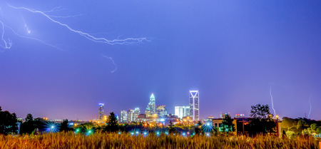 lightning thunder bolts over charlotte skylineの写真素材
