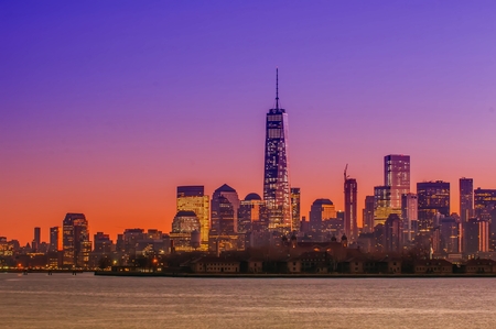 New York City Manhattan midtown panorama at dusk with skyscrapers illuminated over hudson