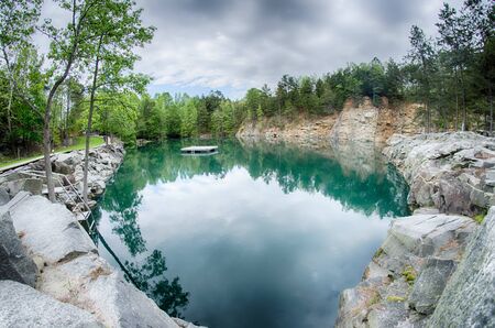 cloudy skies and reflections at a quarryの写真素材