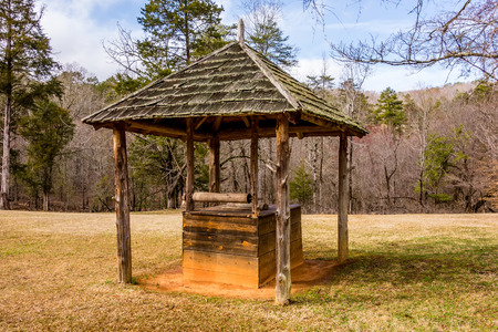 old historic water well in the forestの写真素材
