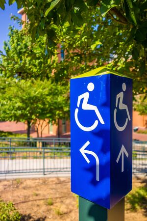blue handicapped wheel chair post signの写真素材