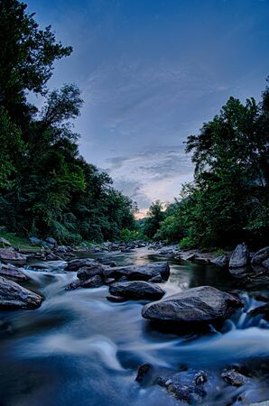 river stream flowing over rocksの写真素材