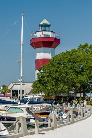 A clear blue sky features the Harbour Town Lighthouse - famous landmark in Hilton Head, SC, USAのeditorial素材