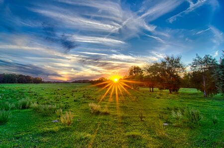 sun setting over country farm land in york south carolina