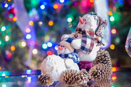 smiling merry christmas snowman with christmas lightsの写真素材