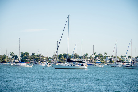 Marina boat masts and reflections background on a sunny dayの写真素材