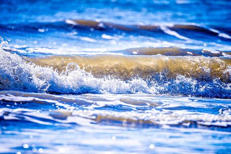 Close up view of beautiful blue ocean wave with white foamの写真素材