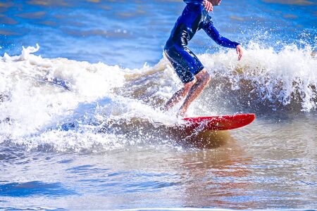 surfer dude on a surfboard riding ocean waveの写真素材