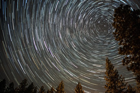 universe spiraling around north star on night skyの写真素材