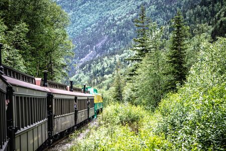 SKAGWAY, ALASKA, USA - JUNE 2017 - Alaskan Canadian White Pass train ride attraction through british columbia canadian rocky mountainsのeditorial素材