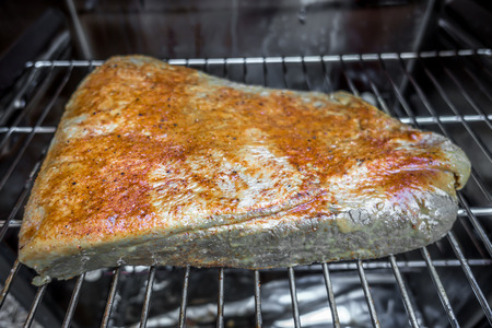 slab of brisket meat in an electric bbq smokerの写真素材